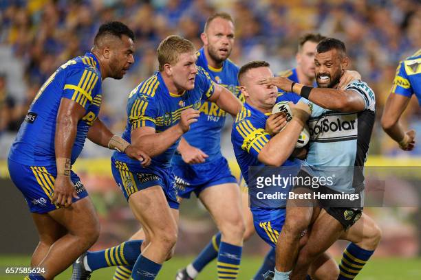 Jayson Bukuya of the Sharks is tackled during the round four NRL match between the Parramatta Eels and the Cronulla Sharks at ANZ Stadium on March...