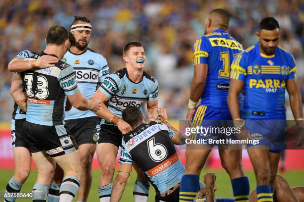 James Maloney of the Sharks celebrates with Jayden Brailey of the Sharks after scoring during the round four NRL match between the Parramatta Eels...