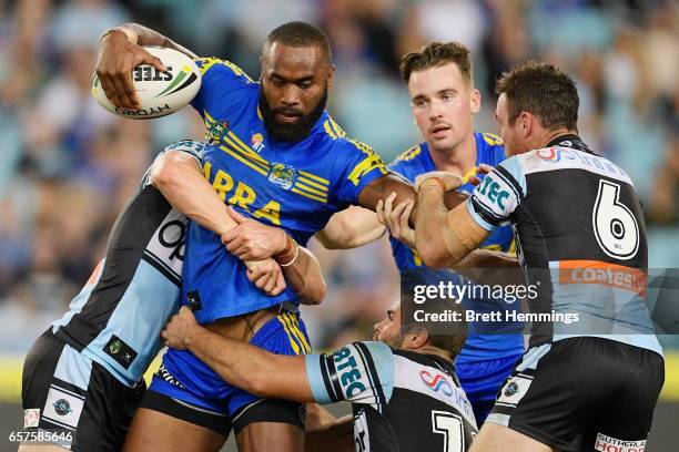 Semi Radrada of the Eels is tackled during the round four NRL match between the Parramatta Eels and the Cronulla Sharks at ANZ Stadium on March 25,...