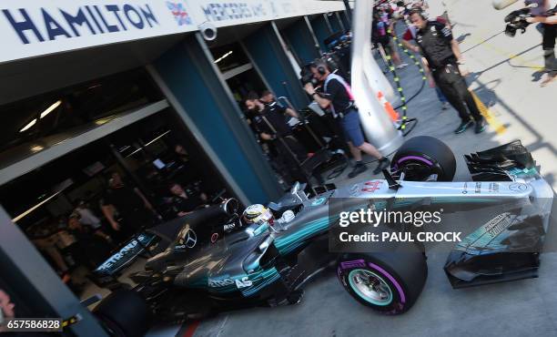 Mercedes' British driver Lewis Hamilton leaves the garage during the third practice session for the Formula One Australian Grand Prix in Melbourne on...