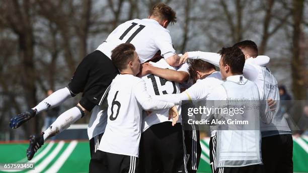 Aymen Barkok of Germany celebrates his team's first goal with team mates during the UEFA Elite Round match between U19 Germany and U19 Serbia at...