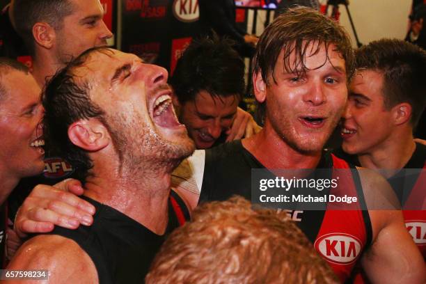 Jobe Watson and Michael Hurley of the Bombers sing the club song after winning during the round one AFL match between the Essendon Bombers and the...