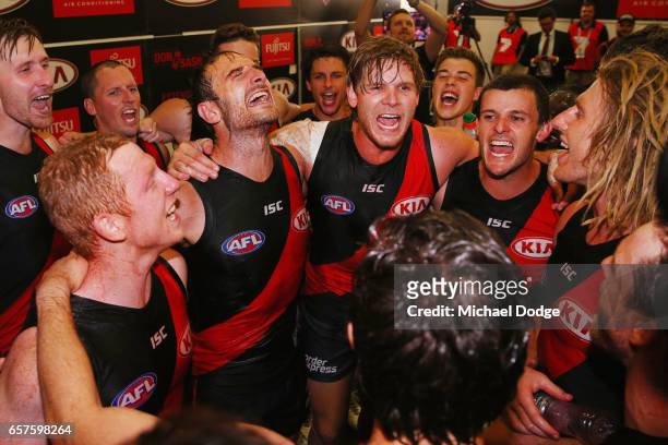 Josh Green, Jobe Watson,Michael Hurley, Brent Stanton and Dyson Heppell of the Bombers sing the club song after winning during the round one AFL...