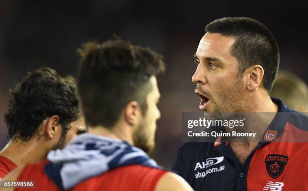 Troy Chaplin the assistant coach of the Demons talks to his players during the round one AFL match between the St Kilda Saints and the Melbourne...