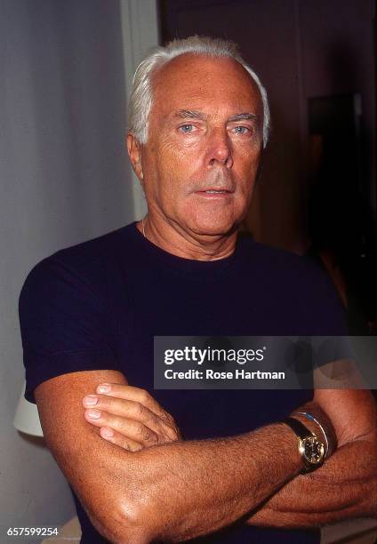 Portrait of Italian fashion designer Giorgio Armani as he poses, arms crossed at the Armani boutique , New York, New York, 1992.