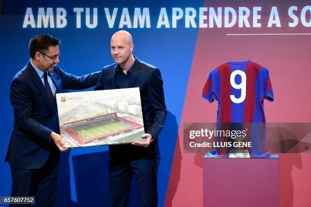 Barcelona's president Josep Maria Bartomeu and son of late Dutch football star Johan Cruyff, Jordi Cruyff pose with a photo of the project of new...