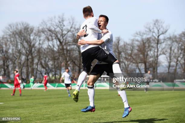 Jonas Busam of Germany celebrates his team's second goal with team mate Dominik Franke during the UEFA Elite Round match between U19 Germany and U19...