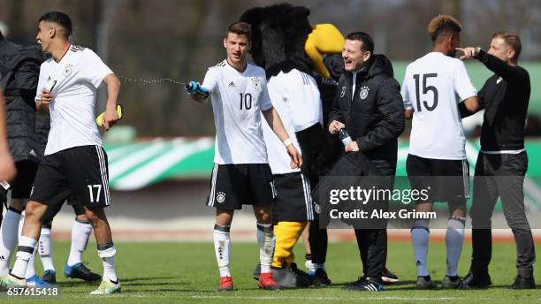 Head coach Frank Kramer of Germany and players celebrate after the UEFA Elite Round match between U19 Germany and U19 Serbia at Sportpark on March...