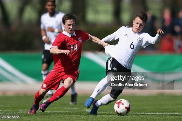 Dennis Geiger of Germany is challenged by Damjan Gojkov of Serbia during the UEFA Elite Round match between U19 Germany and U19 Serbia at Sportpark...