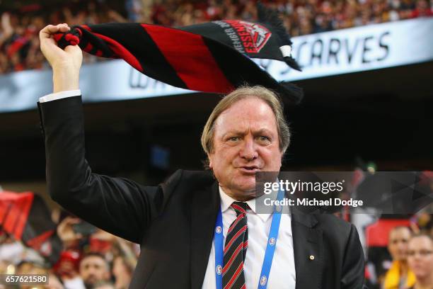 Bombers legend Kevin Sheedy aves his scarf during the round one AFL match between the Essendon Bombers and the Hawthorn Hawks at Melbourne Cricket...