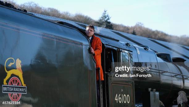 Fireman Adrian Clark-Monks looks out from the footplate of the steam locomotive Royal Scot at Grosmont engine sheds on the North Yorkshire Moors...