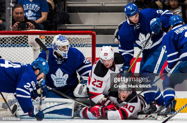 Blake Coleman and Stefan Noesen of the New Jersey Devils battles with Curtis McElhinney, Brian Boyle, Alexey Marchenko of the Toronto Maple Leafs...