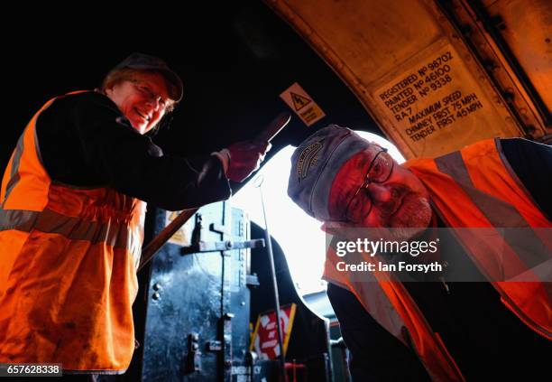 Support crew volunteers Diana Hurfurt and John Blair check the fire of the steam locomotive Royal Scot in Grosmont engine sheds ahead of running...