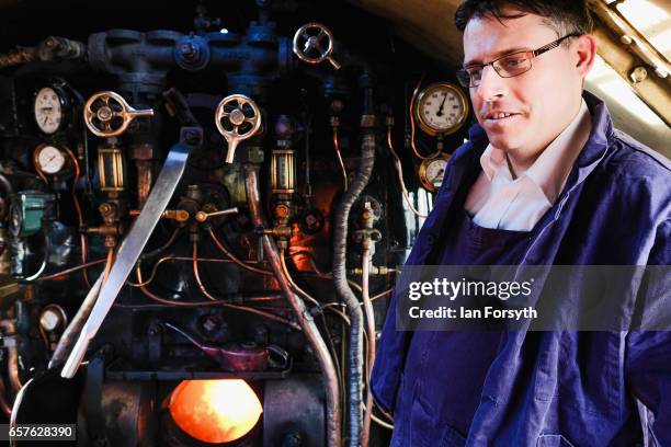 Fireman Adrian Clark-Monks stands on the footplate of the steam locomotive Royal Scot at Grosmont engine sheds on the North Yorkshire Moors Railway...