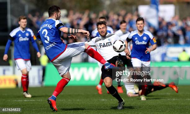 Michel Niemeyer of Magdeburg competes with Dominik Schmidt of Kiel during the Third League match between Holstein Kiel and 1. FC Magdeburg at...