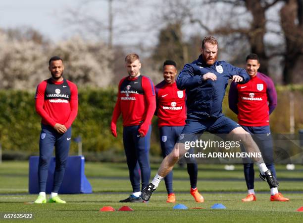 Australian coach Bryce Kavanagh demonstrates an exercise to England's defender Ryan Bertrand, England's defender Luke Shaw, England's defender...