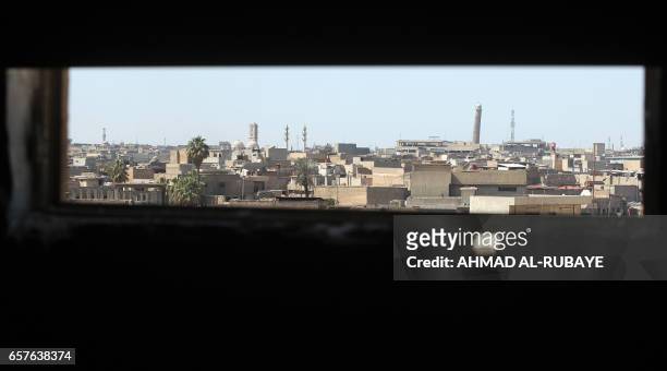 General view taken on March 25 shows the Mosul skyline featuring the historic leaning Al-Hadba minaret near the Great Mosque of Al-Nuri in Mosul,...