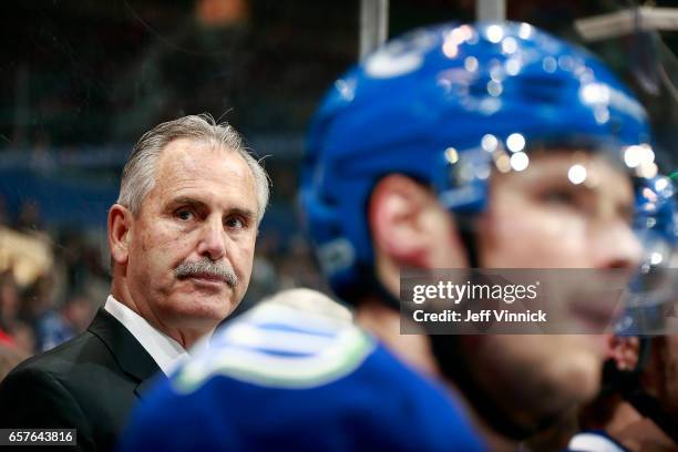 Head coach Willie Desjardins of the Vancouver Canucks looks on from the bench during their NHL game against the Detroit Red Wings at Rogers Arena...