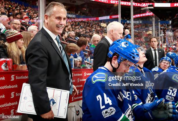 Head coach Willie Desjardins of the Vancouver Canucks looks on from the bench during their NHL game against the Detroit Red Wings at Rogers Arena...