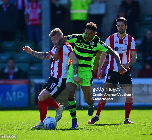 Lincoln City's Alan Power vies for possession with Forest Green Rovers' Kaiyne Woolery during the Vanarama National League match between Lincoln City...