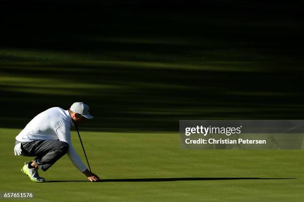 Ross Fisher of England lines up a putt on the 3rd hole of his match during round four of the World Golf Championships-Dell Technologies Match Play at...