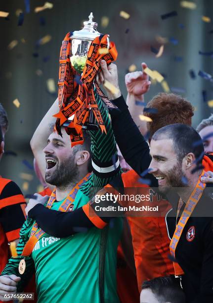 Cammy Bell of Dundee United holds the trophy a loft during the Irn-Bru Cup Final between Dundee United and St Mirren at Fir Park on March 25, 2017 in...