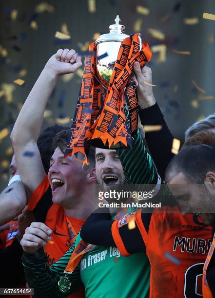Cammy Bell of Dundee United holds the trophy a loft during the Irn-Bru Cup Final between Dundee United and St Mirren at Fir Park on March 25, 2017 in...