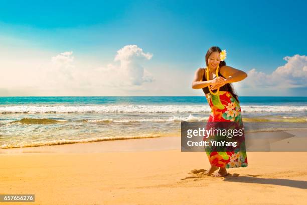 hawaiian hula dancer dancing on the beach - hawaiian print dress stock pictures, royalty-free photos & images