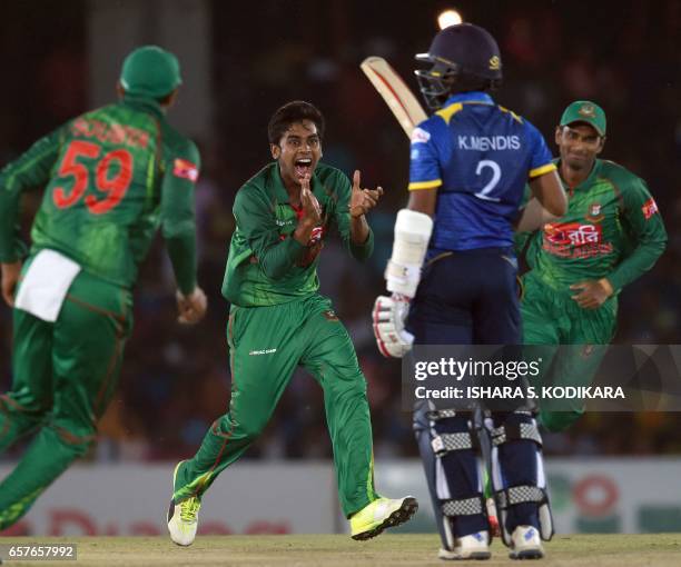 Bangladesh cricketer Mehedi Hasan celebrates with teammates after he dismissed Sri Lankan cricketer Kusal Mendis during the first one day...