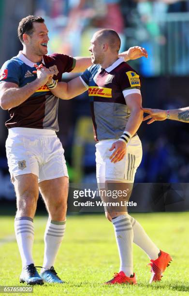 Mike Brown of Harlequins celebrates scoring a try with team mate Tim Visser during the Aviva Premiership match between Harlequins and Newcastle...