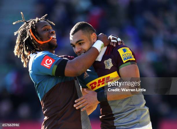 Joe Marchant of Harlequins is congratulated by team mate Marland Yarde after scoring an interception try during the Aviva Premiership match between...