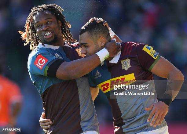 Joe Marchant of Harlequins is congratulated by team mate Marland Yarde after scoring an interception try during the Aviva Premiership match between...