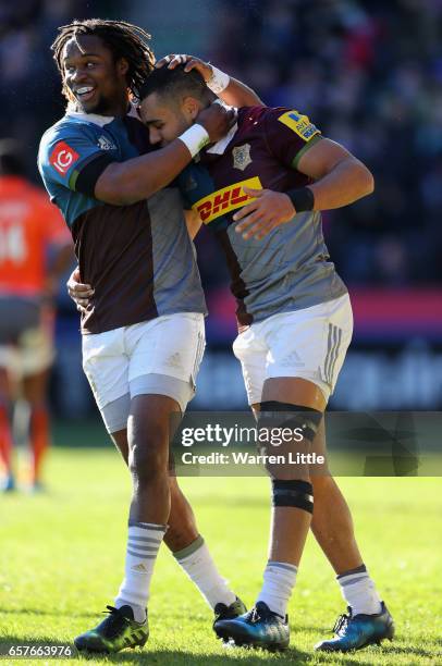 Joe Marchant of Harlequins is congratulated by team mate Marland Yarde after scoring an interception try during the Aviva Premiership match between...