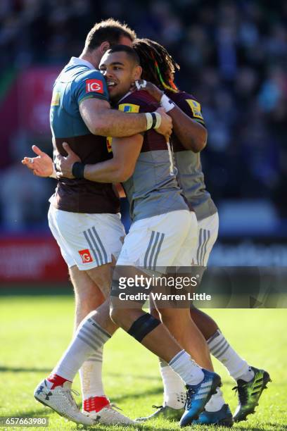 Joe Marchant of Harlequins is congratulated by team mate Marland Yarde after scoring an interception try during the Aviva Premiership match between...