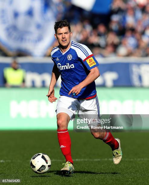 Tim Siedschlag of Kiel runs with the ball during the Third League match between Holstein Kiel and 1. FC Magdeburg at Holstein-Stadion on March 25,...