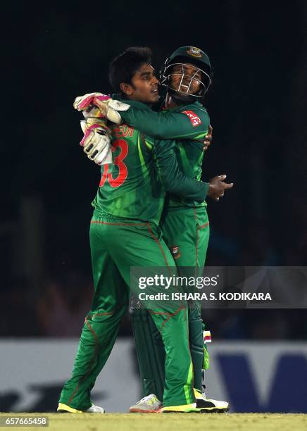 Bangladesh wicketkeeper Mushfiqur Rahim and cricketer Mehedi Hasan celebrate after Rahim dismissed Sri Lankan batsman Dinesh Chandimal during the...