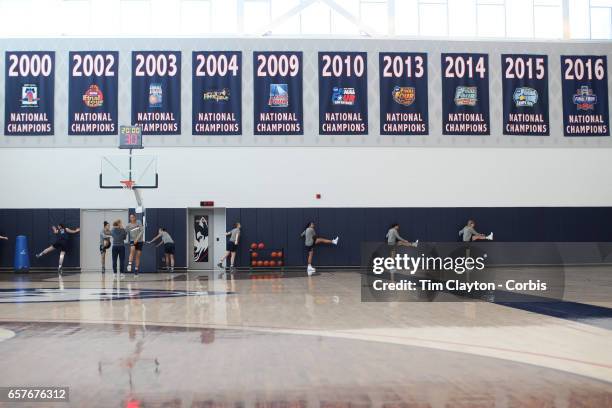 Napheesa Collier, Gabby Williams and Katie Lou Samuelson , with team mates warming up under the National Champions banners while under the...
