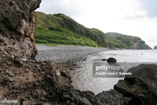 rocky outcrop with a view of the beach - batan location stock pictures, royalty-free photos & images
