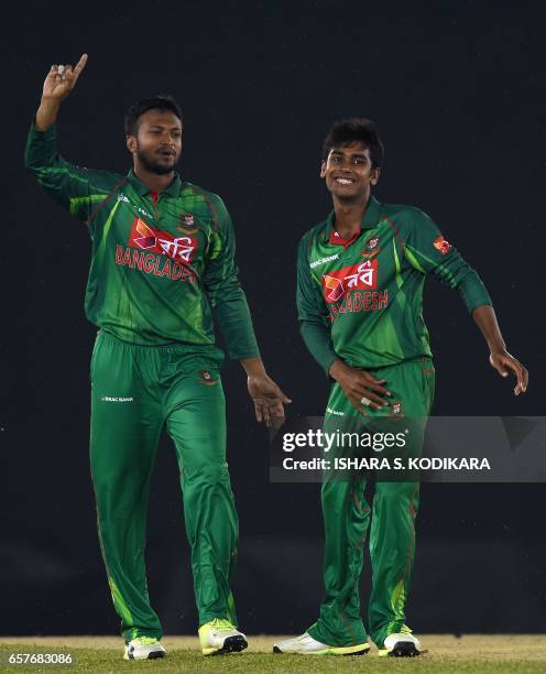 Bangladesh Mehedi Hasan celebrates with teammate Shakib Al Hasan after he dismissed Sri Lankan cricketer Lakshan Sandakan run out during the first...