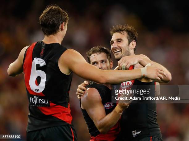 Jobe Watson of the Bombers celebrates on the final siren with Travis Colyer and Joe Daniher of the Bombers during the 2017 AFL round 01 match between...