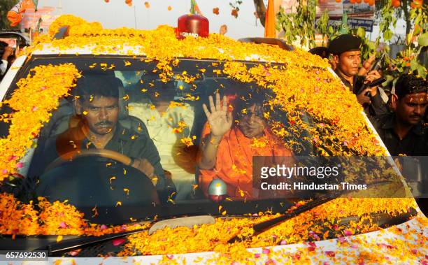 Supporters showering flowers on Uttar Pradesh Chief Minister Yogi Adityanath on his first visit to his hometown Gorakhpur after swearing-in ceremony...