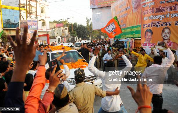 Supporters showering flowers on Uttar Pradesh Chief Minister Yogi Adityanath on his first visit to his hometown Gorakhpur after swearing-in ceremony...