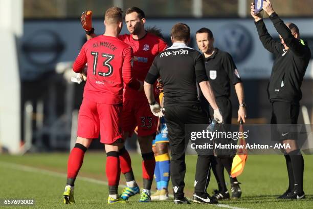 The injured goalkeeper Ben Alnwick is replaced by Mark Howard of Bolton Wanderers during the Sky Bet League One match between Shrewsbury Town and...