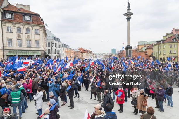 People wave EU and Polish flags during a demonstration 'I Love You Europe' to mark the 60th anniversary of the Rome treaty in Warsaw, Poland on 25...