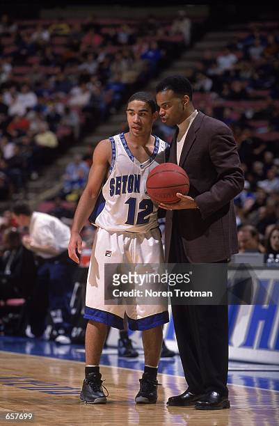 Head COach Tommy Amaker of the Seton Hall Pirates talks to Andre Barrett during the game against the Georgetown Bulldogs at the Continental Airlines...