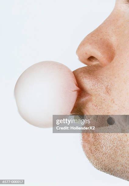 man blows gum bubble - bubble gum stock pictures, royalty-free photos & images