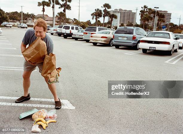 shopper dropping groceries - ignorance stock-fotos und bilder