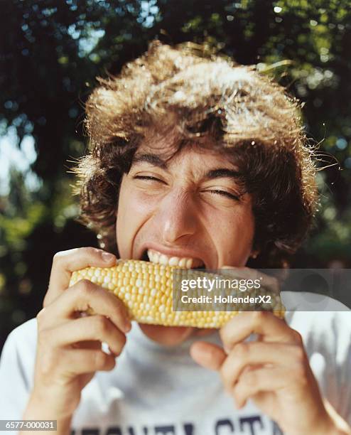 man eating corn - abgebissen stock-fotos und bilder