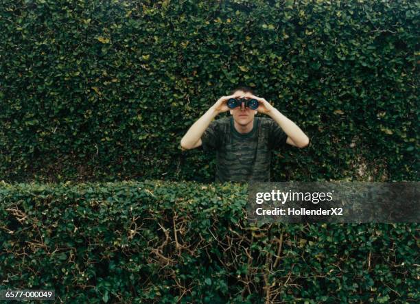 man using binoculars - zoeken stockfoto's en -beelden