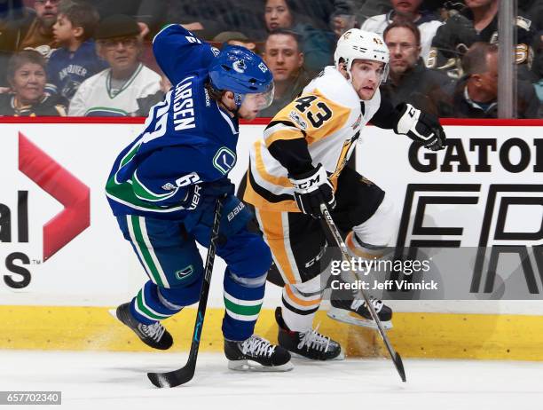 Philip Larsen of the Vancouver Canucks and Conor Sheary of the Pittsburgh Penguins skate up ice during their NHL game at Rogers Arena March 11, 2017...